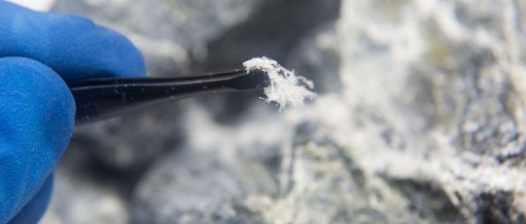 Testing for asbestos – Chrysotile asbestos fiber close up.