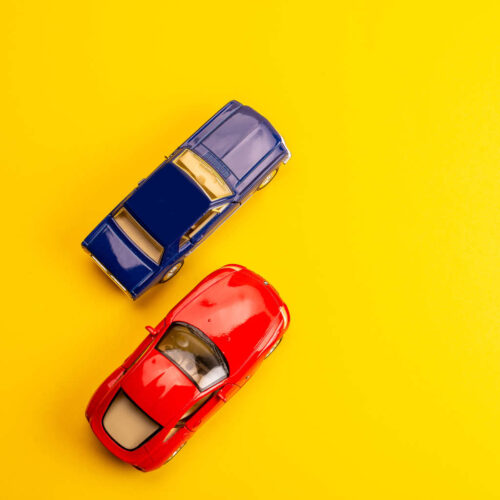 Driver assessment two toys cars on yellow background