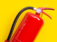 Fire Safety Training eLearning Course - a red fire extinguisher isolated on a yellow background