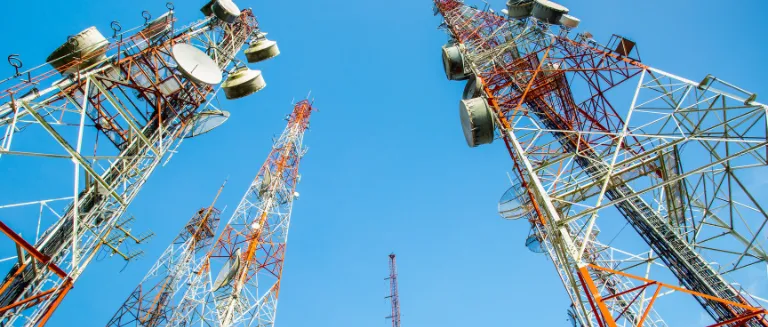 Three communication antenna dominating the blue sky