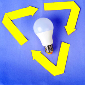A lightbulb framed with yellow arrows in a triangular shape on a blue background to symbolise environmental awareness.