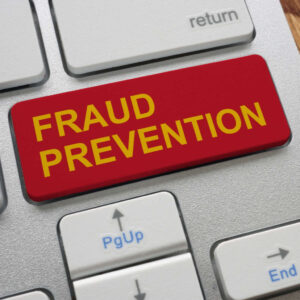 Close up of a keyboard. Below the return key is a big red key that says fraud prevention. Illustrates online fraud prevention training.