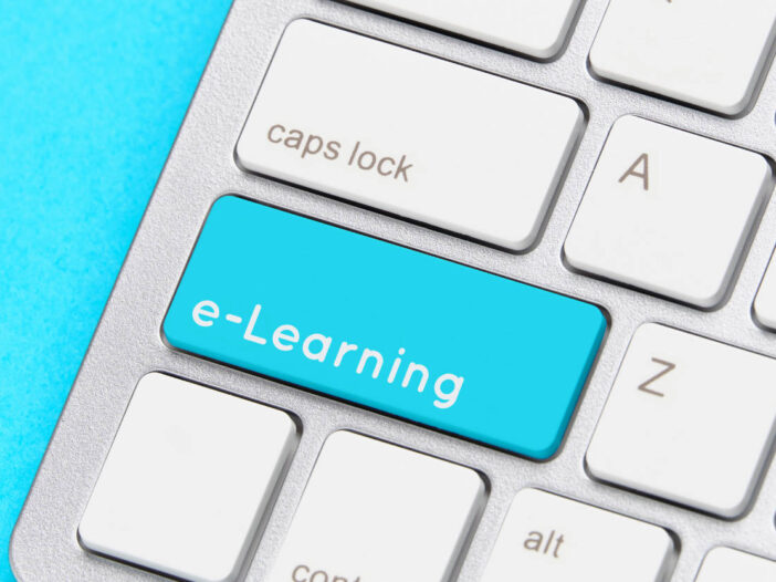 benefits of elearning - Online e-learning concept on keyboard with button.