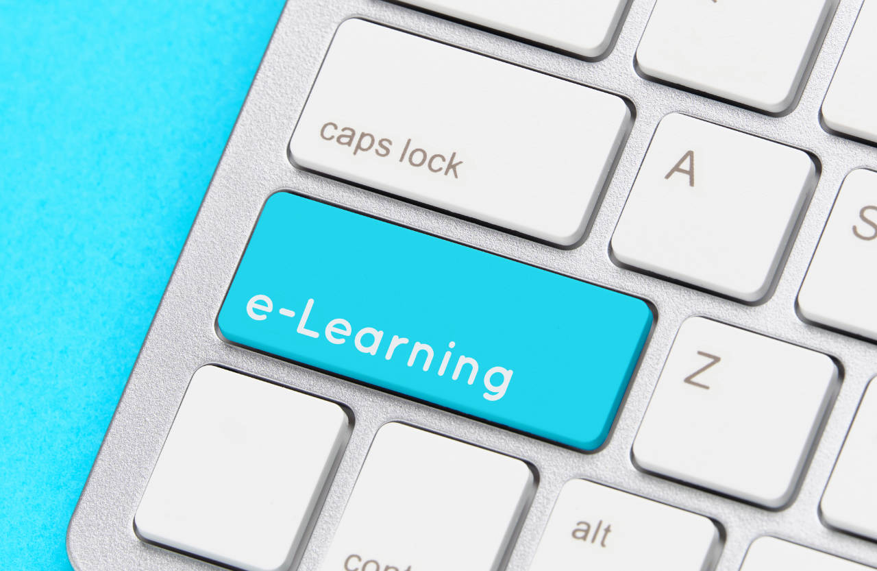 benefits of elearning - Online e-learning concept on keyboard with button.