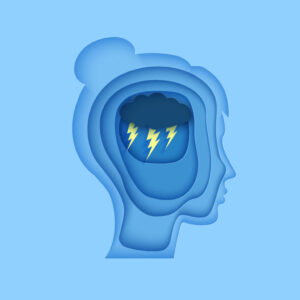 a cut out of a person's head with a storm inside to symbolise mental health challenges