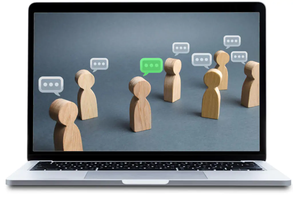 Laptop displaying wooden people with speech bubbles to illustrate managing safely training online.