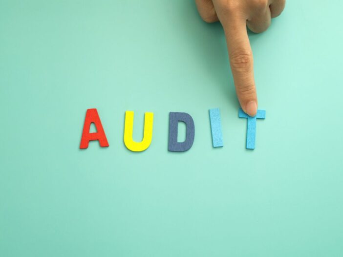 Wooden letters spelling out the word audit for health and safety audit.