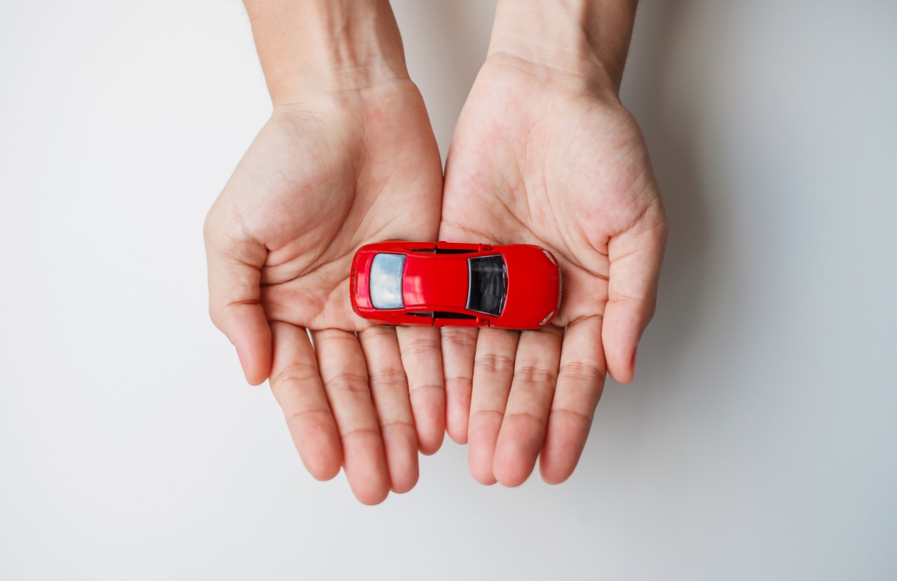 Two hands carefully holding a toy car in a protective way to symbolise managing workplace transport safely through a workplace transport risk assessment.