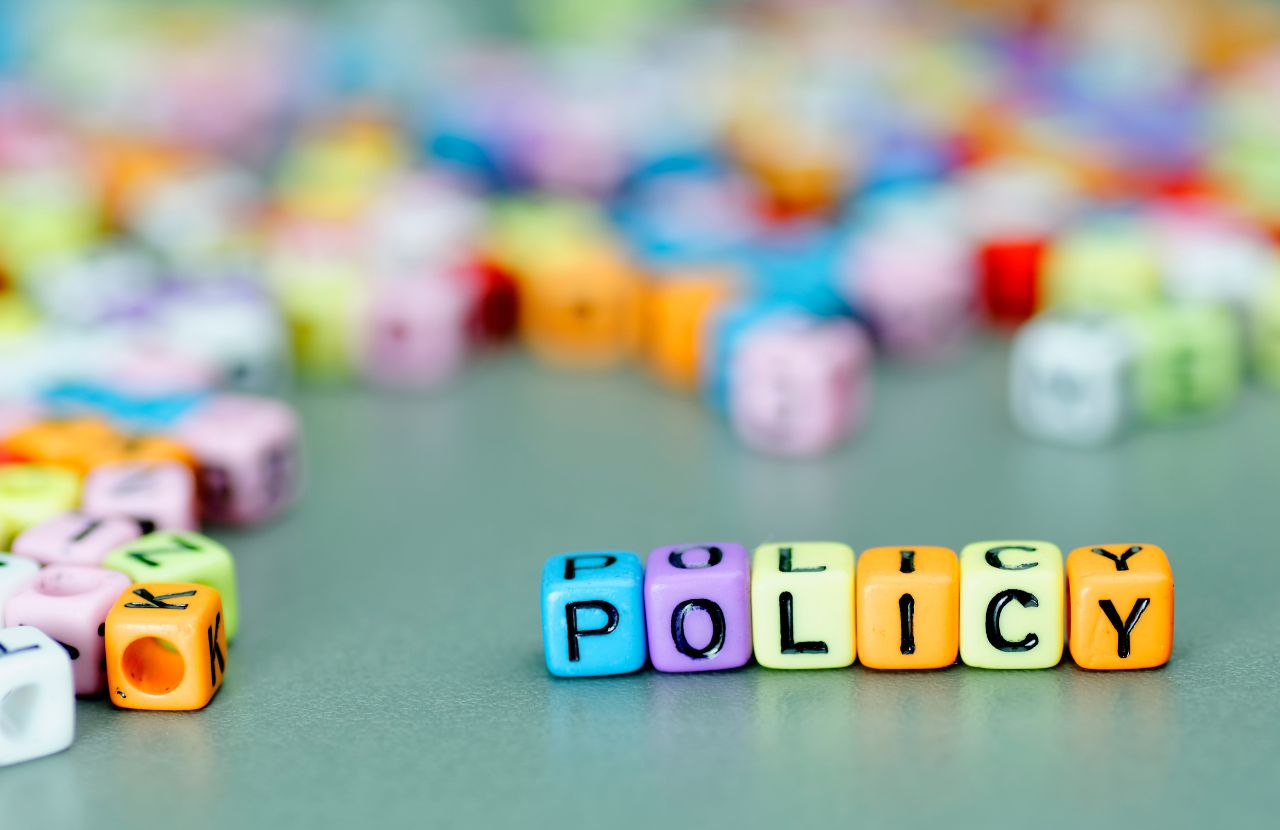 Coloured cubes with letters spelling the word policy to indicate health and safety policy.