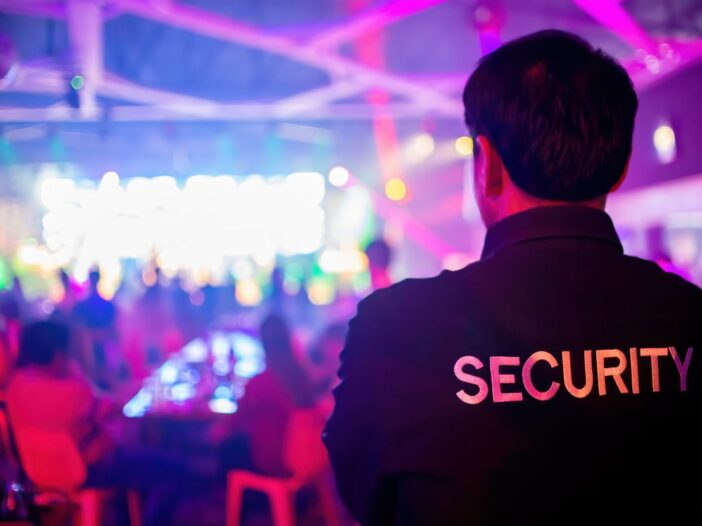 Close up of a security guard watching an indoor event