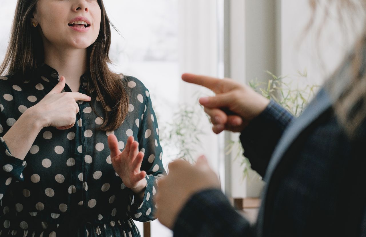 Two employees talking through their differences as an example of managing conflict at work.