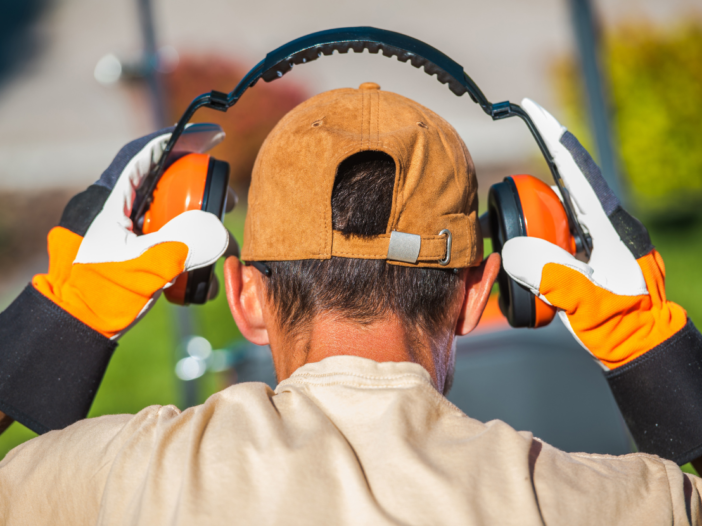 Man wearing ear defenders to symbolise noise exposure limits uk