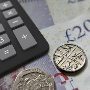 Coins, twenty pound note and a calculator.