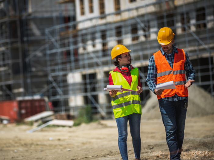 Two people in PPE walking and talking to demonstrate Health and Safety Consultation with Employees Regulations