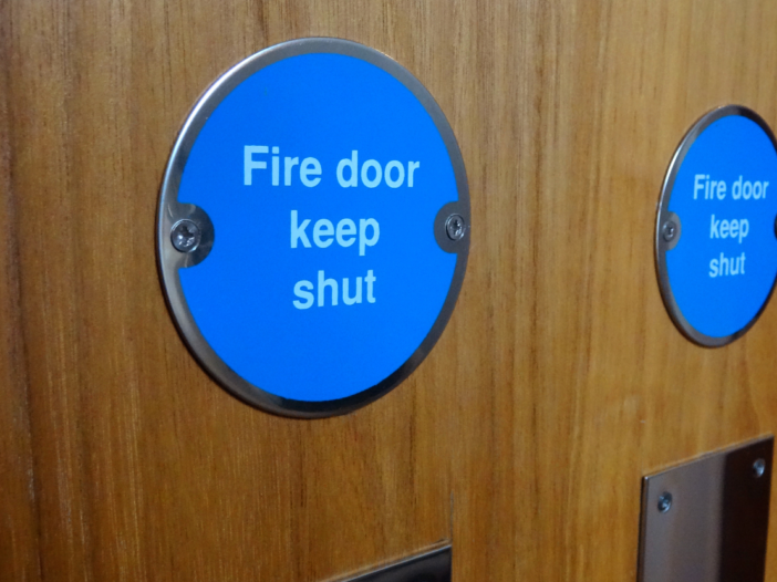 Close up of a fire doors with sign, 'keep door shut'.