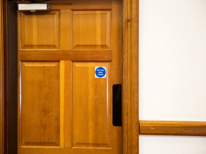 Wooden fire door with 'fire door' signage