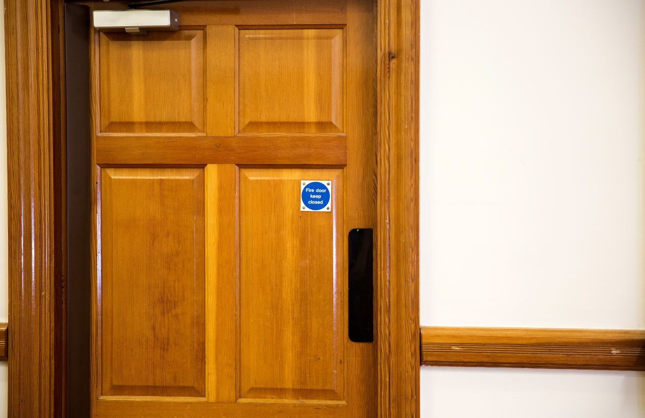 Wooden fire door with 'fire door' signage