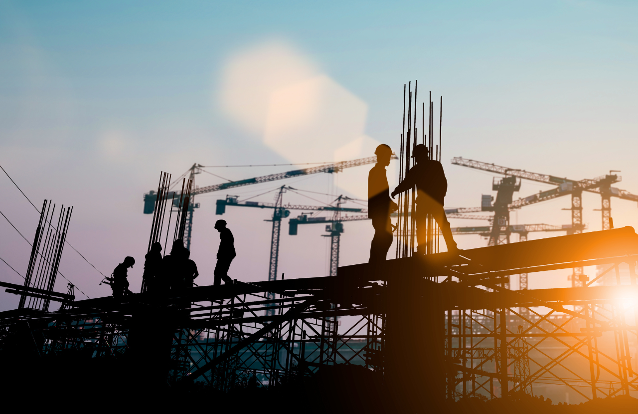 Construction workers on site at dusk