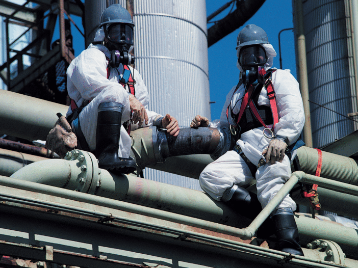 Team on a roof in PPE removing asbestos