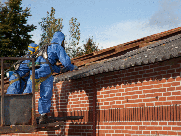 Professional working on a roof to examine asbestos