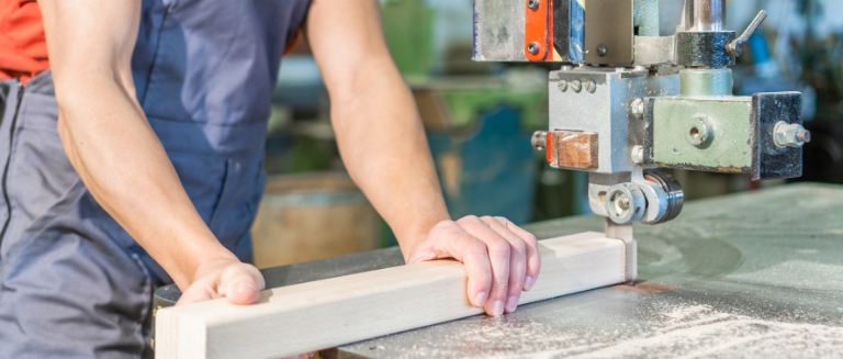 HAVS Training banner image - a worker using a bandsaw to cut wood