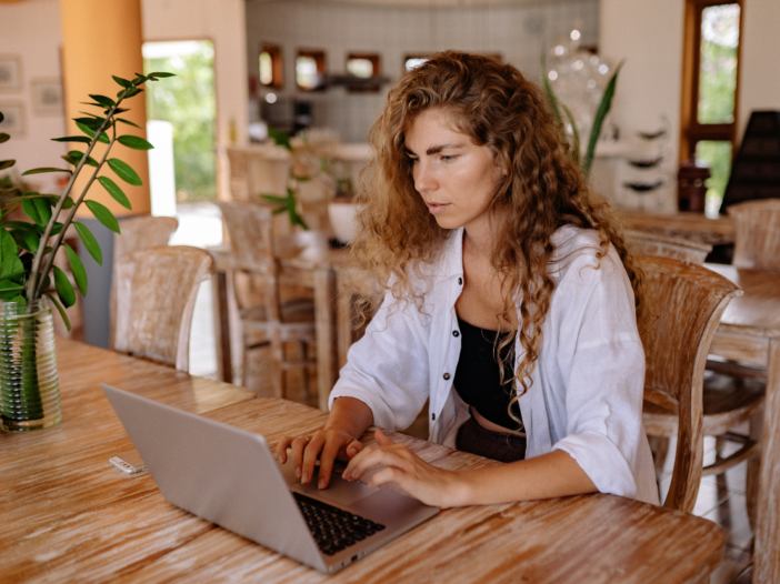 Woman working on laptop in cafe