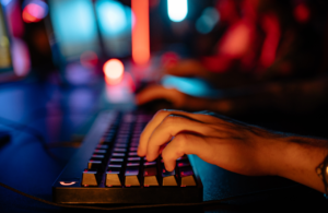 Someone typing on computer keyboard in dark