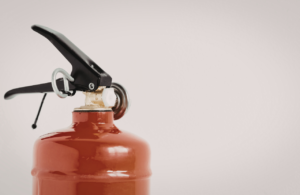 Red fire extinguisher top half with no visible label.