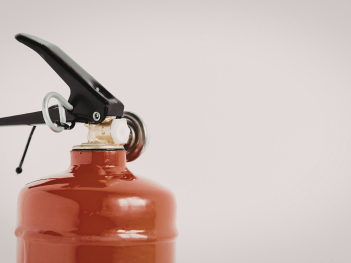 Red fire extinguisher top half with no visible label.