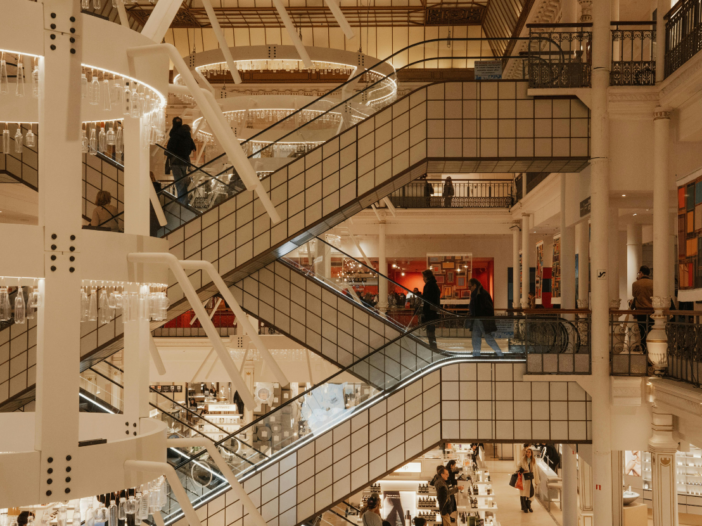 Side view of escalators in an indoor shopping centre to illustrate retail store risk assessment