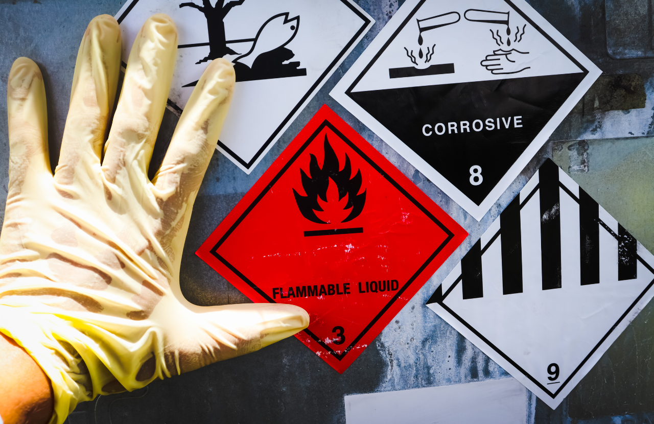 Hand in PPE and hazard symbols to illustrate COSHH guidelines