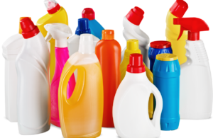 Unlabelled bottles of household chemicals in different colours to represent COSHH safety data sheets