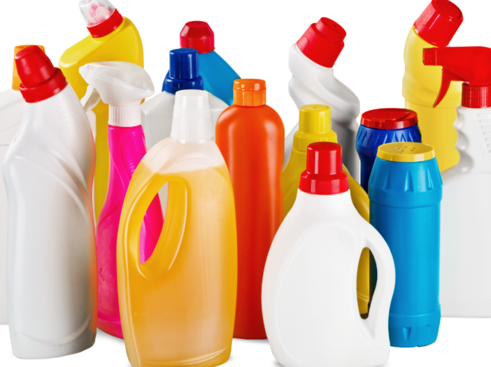 Unlabelled bottles of household chemicals in different colours to represent COSHH safety data sheets