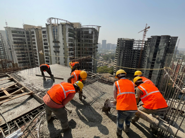 Workers on roof in full PPE to show importance of permit to work system