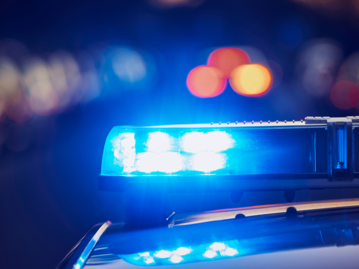 Police car siren close up out of focus at night to illustrate Crime and Policing Act.