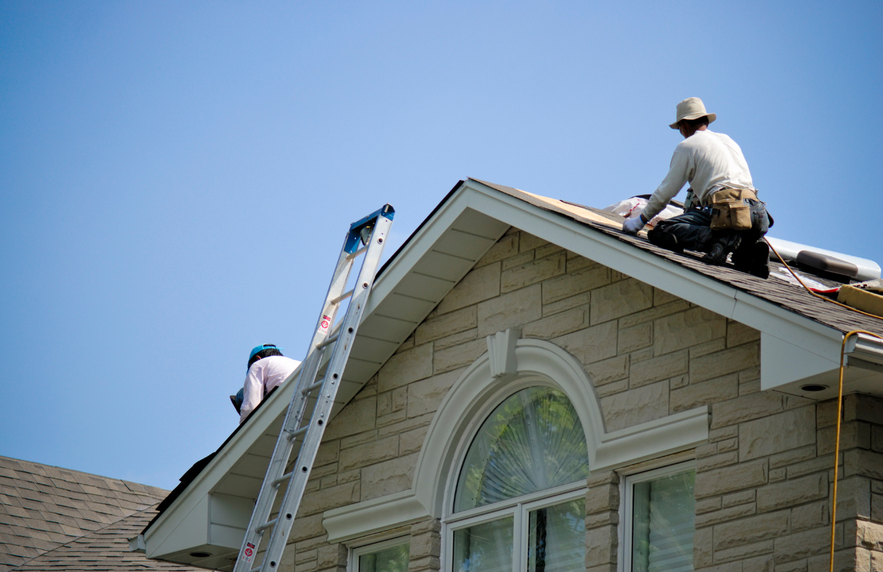 Contractors working on a roof to illustrate what is a construction phase plan