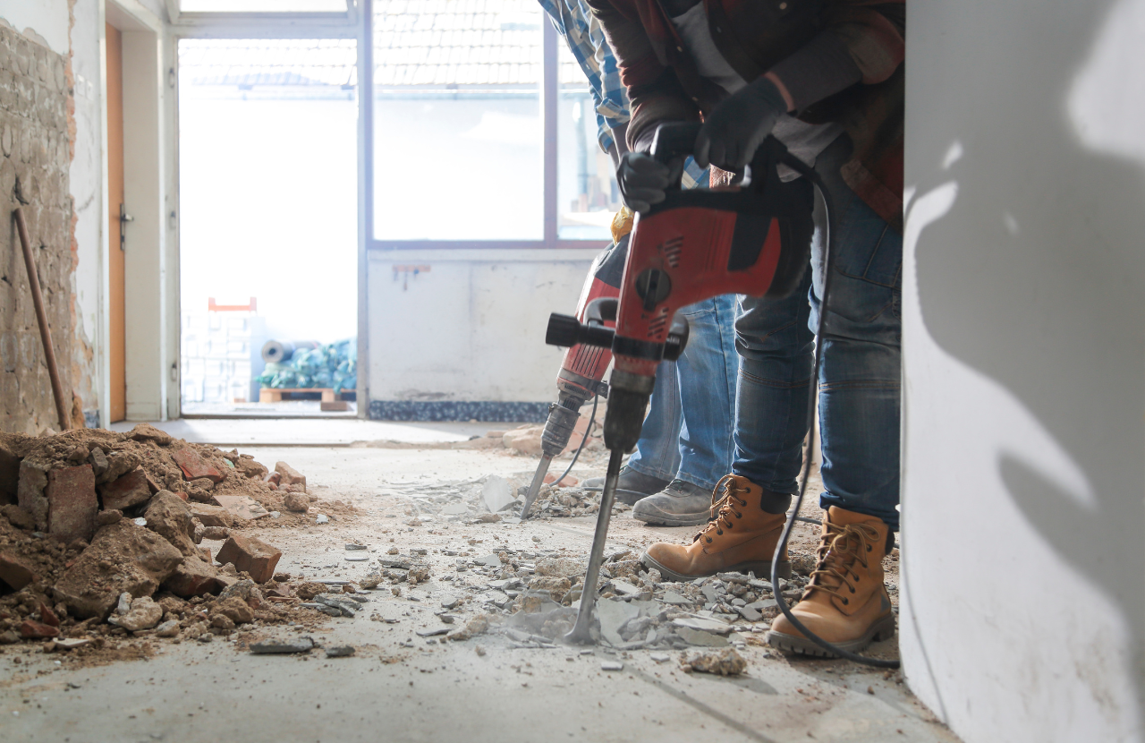 Contractor carrying out home improvements drilling into walls and floor to illustrate when does CDM apply