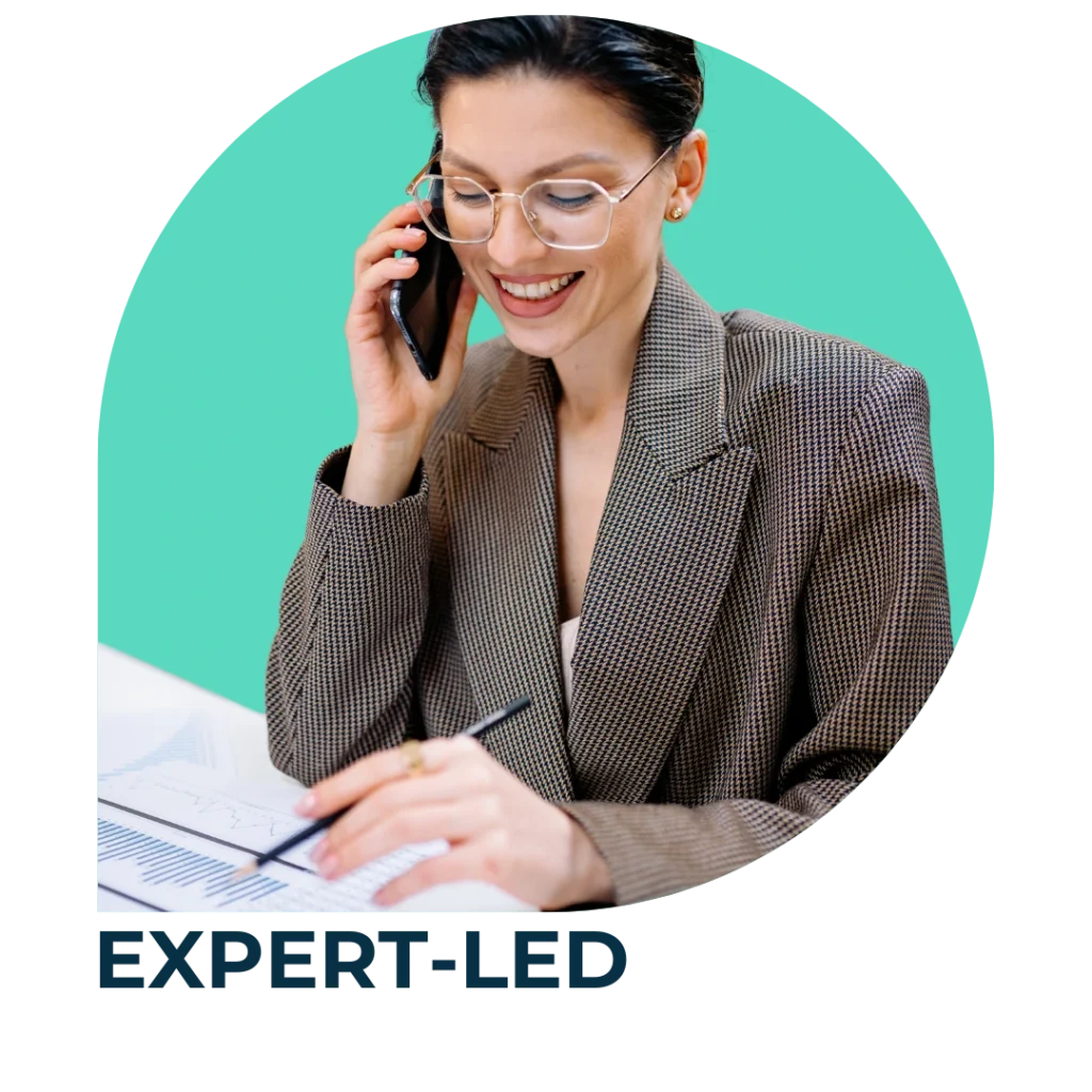 EXPERT-LED: A professional with short black hair and glasses smiling