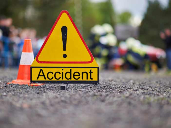 Yellow warning sign with 'accident' and cone in the middle of the road to illustrate accident and incident investigations