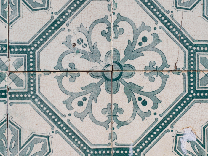 Asbestos kitchen tiles slightly cracked with a symmetrical, pale green pattern to illustrate non licensed work with asbestos