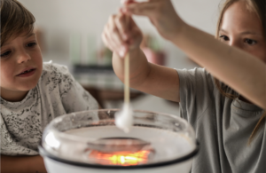 Two children cooking to illustrate health and safety in schools allergies.