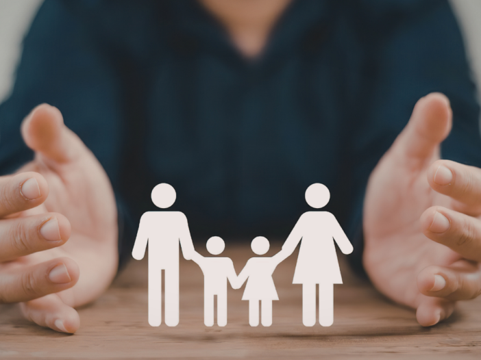 Picture of hands around cardboard figures of a family to represent safeguarding vulnerable groups act 2008