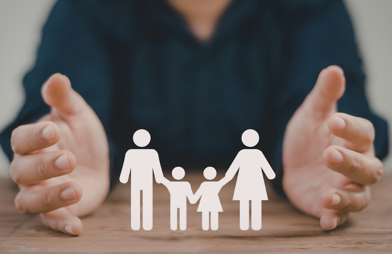 Picture of hands around cardboard figures of a family to represent safeguarding vulnerable groups act 2008
