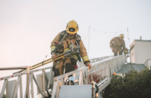 Man in PPE working on roof using a ladder to indicate ladder onto roof