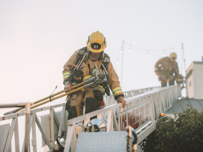 Man in PPE working on roof using a ladder to indicate ladder onto roof
