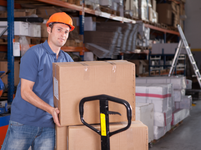 Man in warehouse with hard hat loading boxes onto a forklift to represent mhor meaning