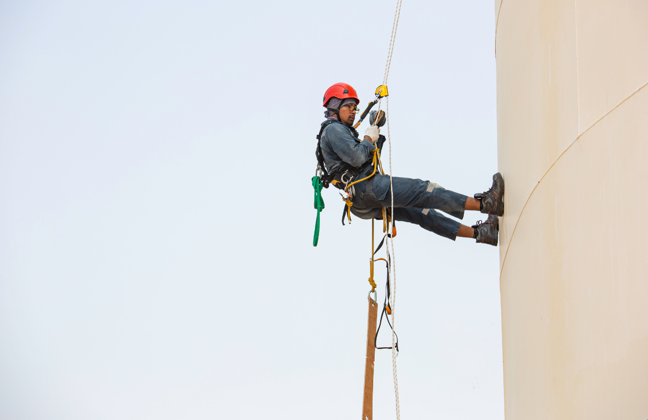 worker in ppe abseiling down a building to indicate working at height specialists